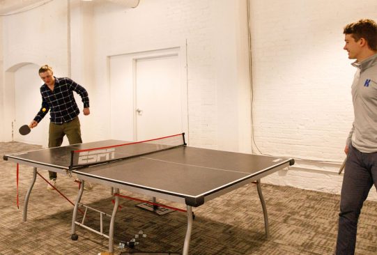 Two men playing ping pong
