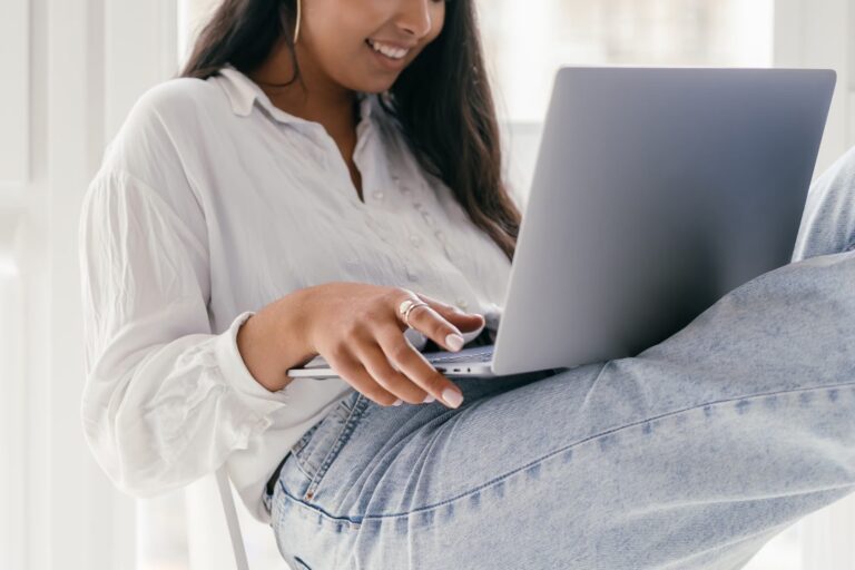 Woman working on computer in her lap