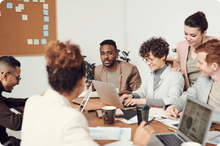 Coworkers in a work meeting with laptops